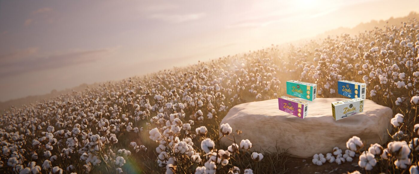 Dadacare Plus cotton tampons in a field of cotton at golden hour
