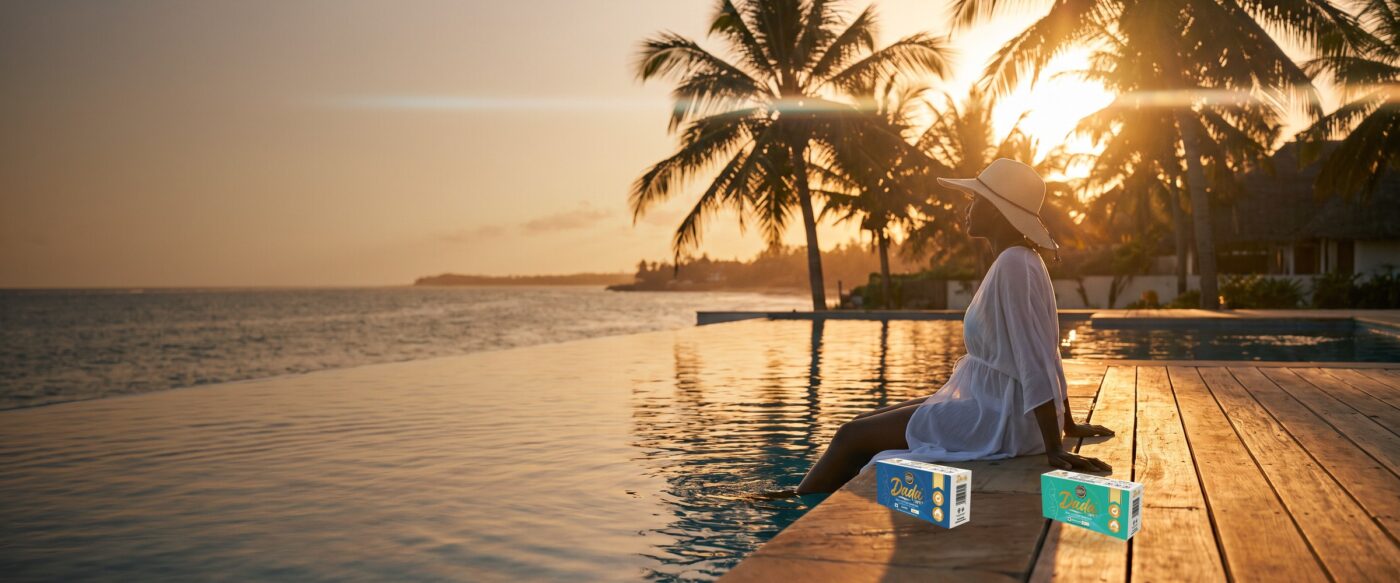Woman relaxing by a coastal infinity pool at sunset with Dadacare Plus tampons