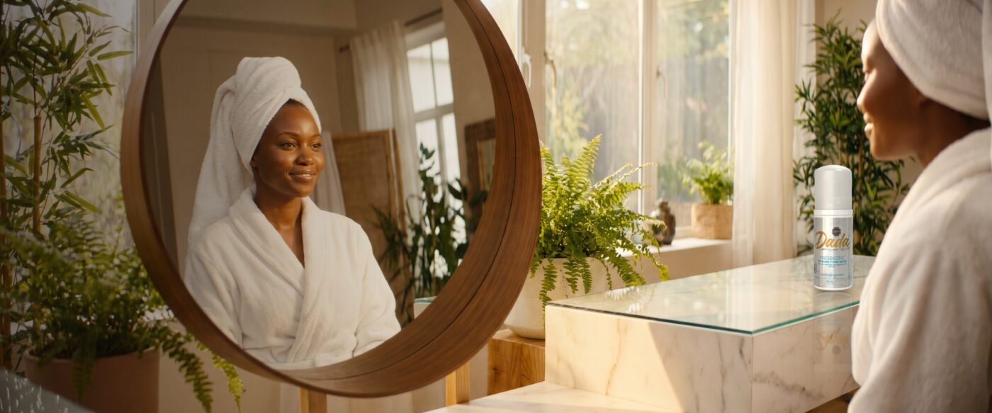 Woman at her bathroom mirror with Dadacare Plus probiotic foam wash